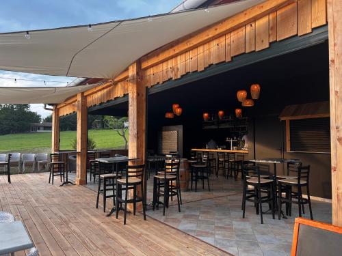 a patio with tables and chairs on a deck at l'Espinet Vacances in Quillan