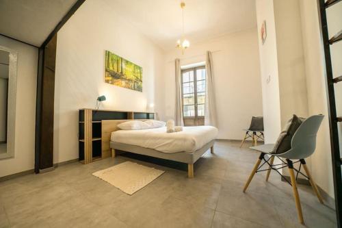 une chambre avec un lit et une chaise dedans dans l'établissement Le Pampille, Grand T2, Climatisé, Centre ville, à Montpellier