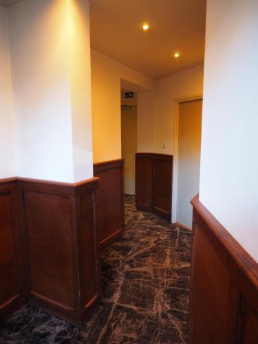 a hallway with a row of stalls in a building at Hotel 't Anker in Leeuwarden