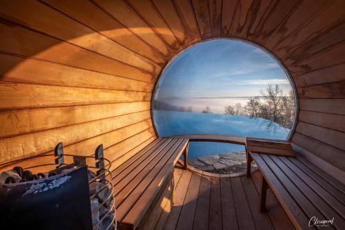 an inside view of a wooden boat with a round window at L'Orée du Bois - Hôtel & Spa in Montagudet