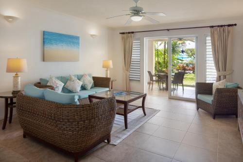 a living room with a couch and chairs and a table at Beach View Hotel in Saint James