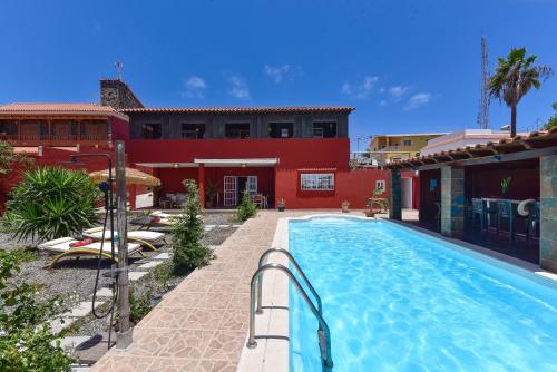 a swimming pool in front of a house at Ca'Sita Salobre Pueblo by VillaGranCanaria in San Bartolomé de Tirajana