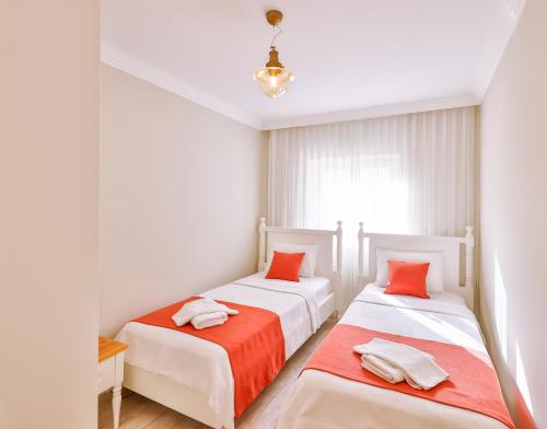 Ένα ή περισσότερα κρεβάτια σε δωμάτιο στο Begonya Suites