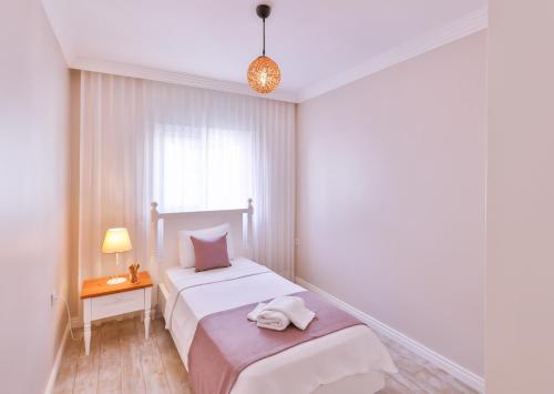 Ένα ή περισσότερα κρεβάτια σε δωμάτιο στο Begonya Suites