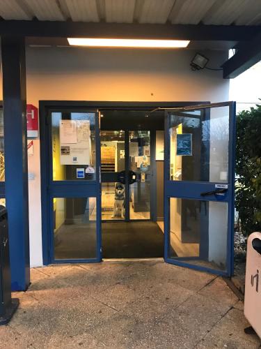 an entrance to an office building with doors open at ibis budget L'Isle Adam in LʼIsle-Adam