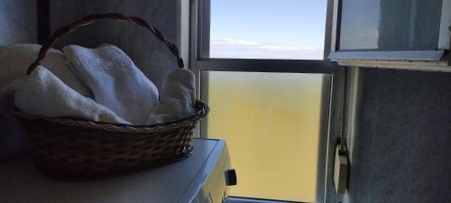 a basket sitting on a counter next to a window at Apartamento Mirando al Mar in San Juan de la Arena