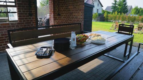 a wooden picnic table with a plate of food on it at Stara Szkola - Wielki Medromierz 59 in Wielki Modromierz