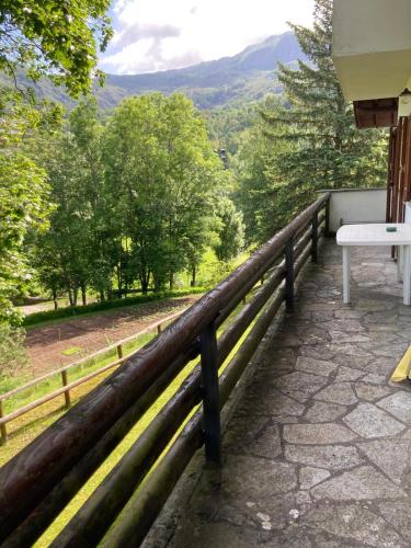 a balcony with a bench and a view of the mountains at Agriturismo La Casa sul Poggio in Santo Stefano dʼAveto