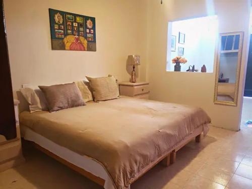 a bedroom with a large bed in a room at OM Studio in Oaxaca City