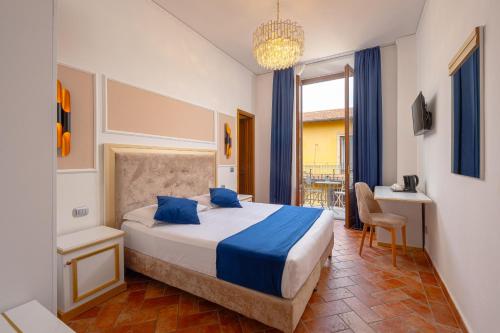 a bedroom with a bed and a chandelier at Hotel Annabella Roof Terrace in Florence