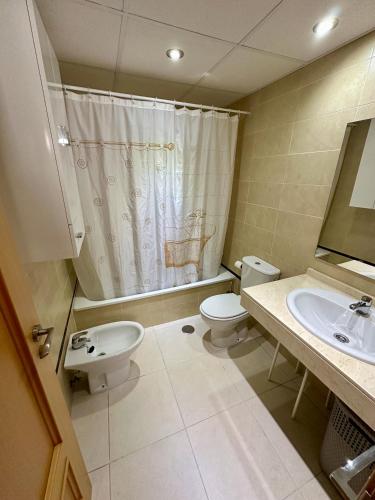 a bathroom with a toilet and a sink at Impresionante Ático en Torre del Mar frente al Mar in Torre del Mar