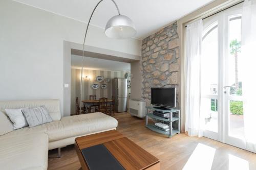 a living room with a white couch and a tv at Villa Rocky - Luxury 3BR Apt in Liberty Villa.Pool,Garden,WiFi in Roquebrune-Cap-Martin