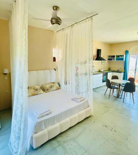 a bedroom with a bed with a mosquito net at Ocean Eyes in Ipsos