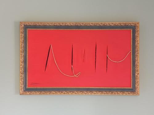a picture of a red painting in a frame at Casa degli Ulivi in Ortona