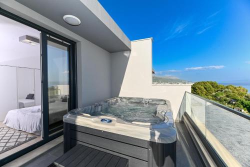 a hot tub on the balcony of a house at Luxury Apartment Skyline in Split