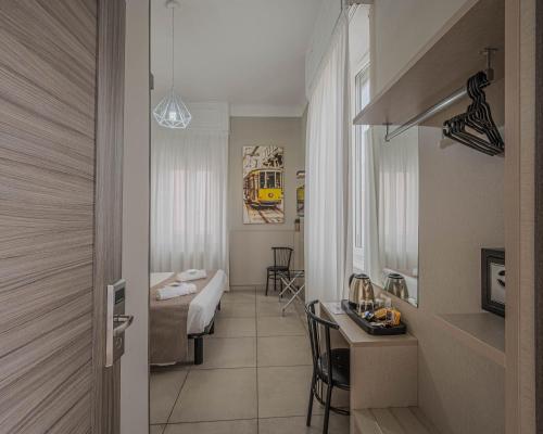 a hotel room with a bed and a desk in a room at Hotel Bogart Milano in Milan