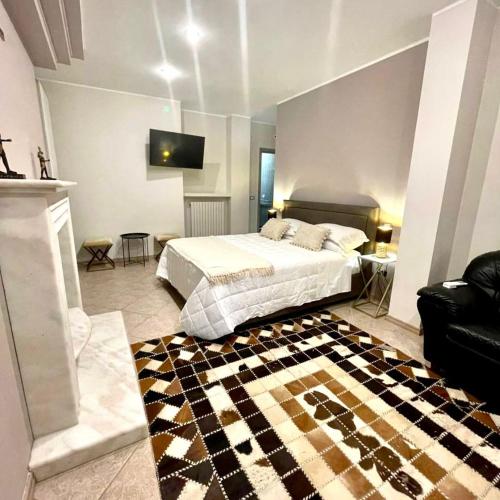 a bedroom with a bed with a checkered rug at Aquada Experience in Francavilla al Mare