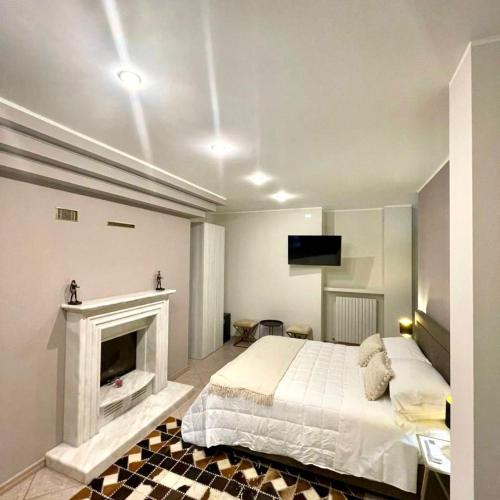 a bedroom with a bed and a fireplace at Aquada Experience in Francavilla al Mare