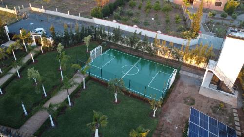 an overhead view of a tennis court in a park at Bens White House in AÃ¯n el Ksob