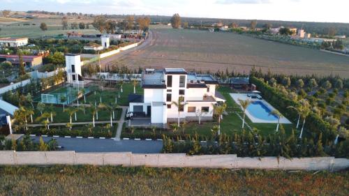 an aerial view of a house in a field at Bens White House in AÃ¯n el Ksob