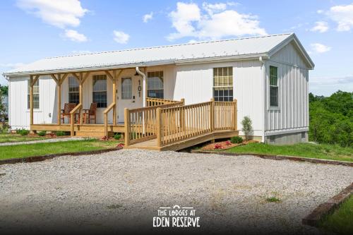 a large white house with a large porch at Lodge 101 at Eden Reserve Near Ark in Williamstown