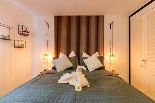 a bedroom with a bed with a stuffed animal on it at Romantisches Cottage mit Sauna, Terrasse & Natur in Münchsteinach