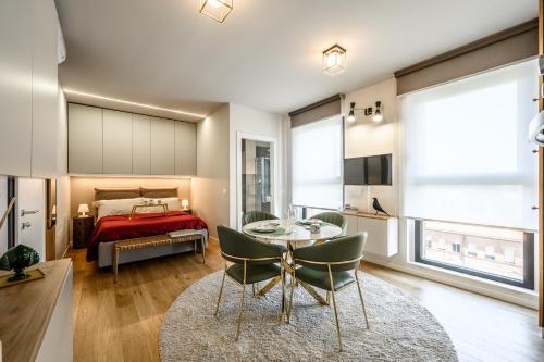 a room with a table and chairs and a bed at Tiny House Tower in Fidenza