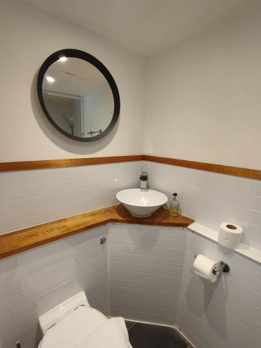 a bathroom with a sink and a toilet and a mirror at The Willows in Brighton & Hove