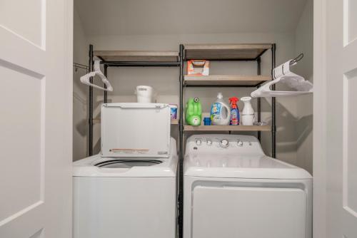 a small kitchen with a stove and a refrigerator at The Rose Retreat - Walk to the Broken Arrow Rose District in Broken Arrow