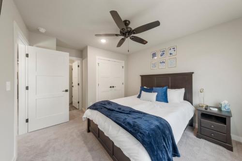 a bedroom with a bed and a ceiling fan at The Rose Retreat - Walk to the Broken Arrow Rose District in Broken Arrow