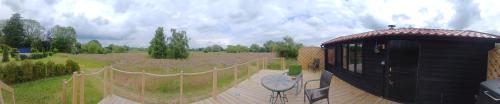 a small building on a wooden deck in a field at The Cabin in Pakenham