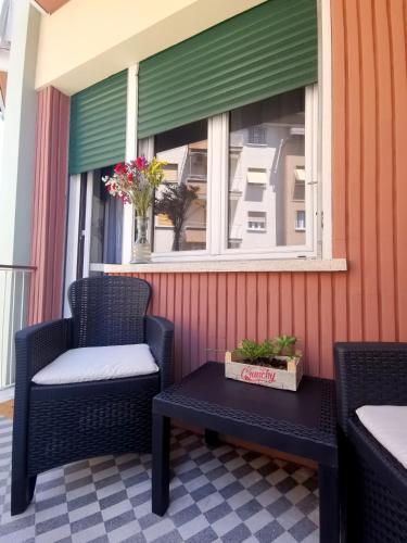 a porch with two chairs and a table and a window at Cipro Home in Rome