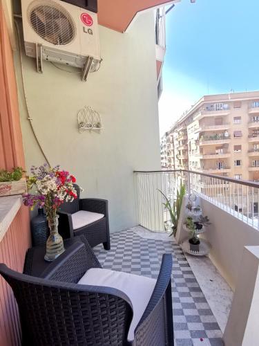 a balcony with a table and chairs and a heater at Cipro Home in Rome