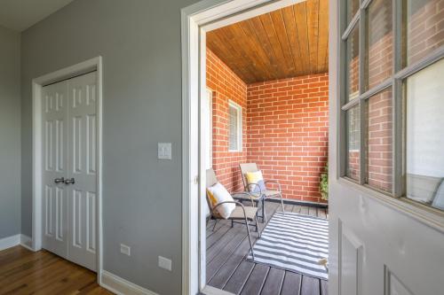 an open door to a balcony with a brick wall at Kenwood Apartments, Downtown Hyde Park in Chicago