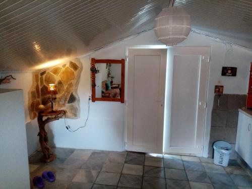 a room with a door and a lamp and a wall at Amfialos in Skala Kallirakhis