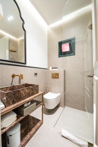 a bathroom with a sink and a toilet at La Fe Boutique Hotel Sarande in Sarandë