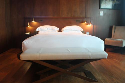 a large white bed in a room with a chair at Hyatt Centric Levent Istanbul in Istanbul