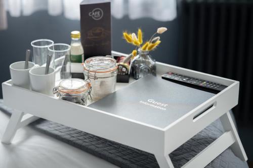 a white coffee table with a remote control on it at St Martins Lodge in Leicester
