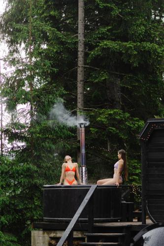 two women are sitting on a train with smoke at GM Eco Bubble in Yablunytsya