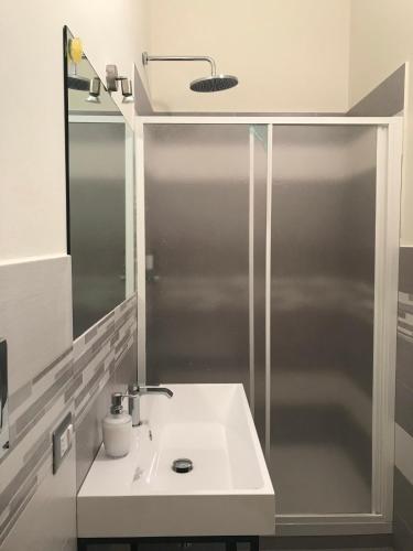 a bathroom with a white sink and a shower at B&B Ciocca I in Campobasso
