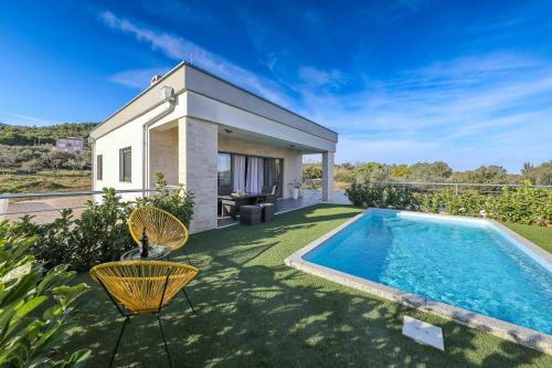 a villa with a swimming pool in a yard at Orchid Stay in Ždrelac