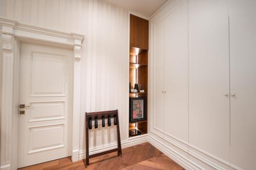 a hallway with white walls and a white door at La Fe Boutique Hotel Sarande in Sarandë