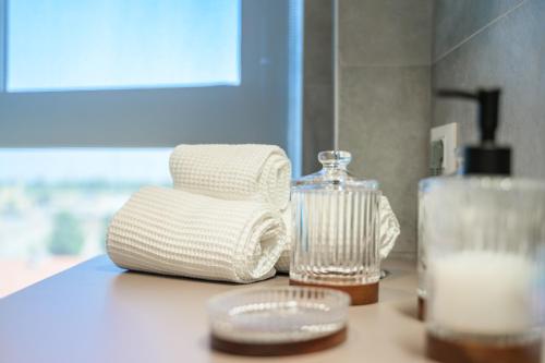 a counter top with a bottle of soap and a glass at Tiny House Tower in Fidenza