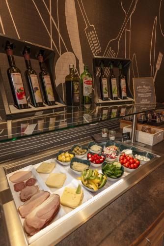 a buffet line with different types of meats and cheese at Appartements Erzherzog Johann in Schladming