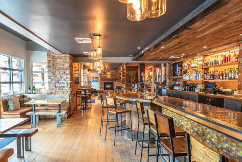 a restaurant with a bar with tables and chairs at The Lodge at Tiburon in Tiburon