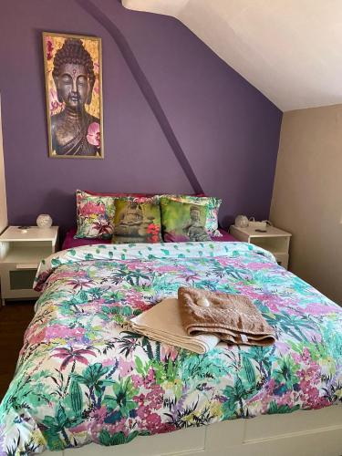 a bedroom with a king sized bed with a painting on the wall at The Paintshop Hostel in Figueira da Foz