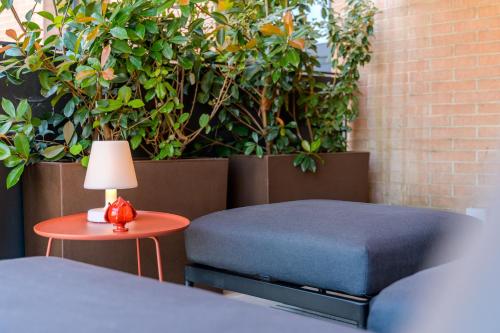 a bedroom with a bed and a table with a lamp at Tiny House Tower in Fidenza