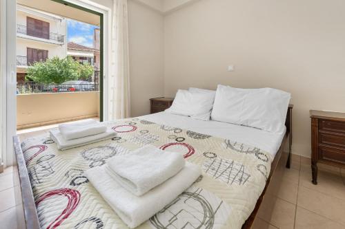 a bedroom with a bed with towels on it at Abatis CityHome in Lefkada