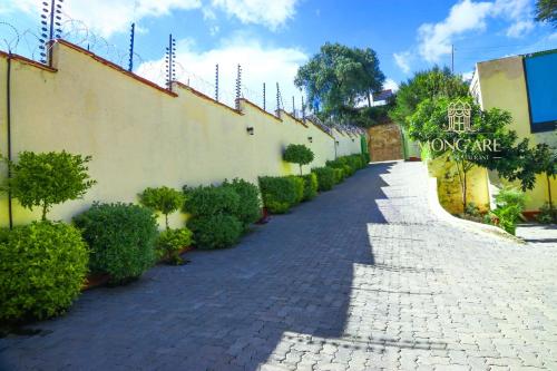 a stone pathway in front of a building at Mong'are Lodge and Restaurant, Narok in Narok