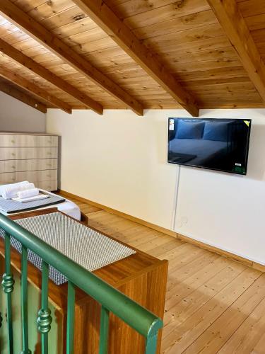 a living room with a flat screen tv on the wall at Villa Georgia in Kastrosikia